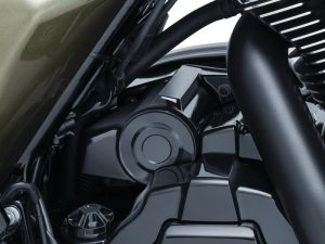 Detailed motorcycle engine close-up with black components and sleek design highlights.