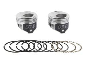 Piston kit with piston rings and circlips for motorcycle engine repair.