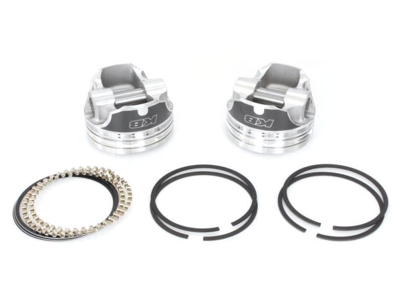 Precision motorcycle pistons with piston rings and pins for Harley-Davidson bikes.