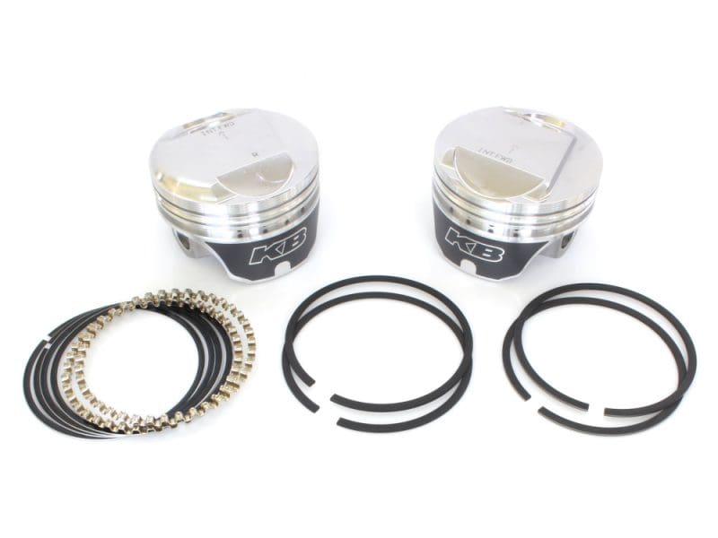 High-performance motorcycle pistons with piston rings and connecting rod bolts for Revelry Motorcycles.