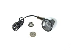 Compact motorcycle LED headlight with wiring and mounting hardware for Revelry Motorcycles.