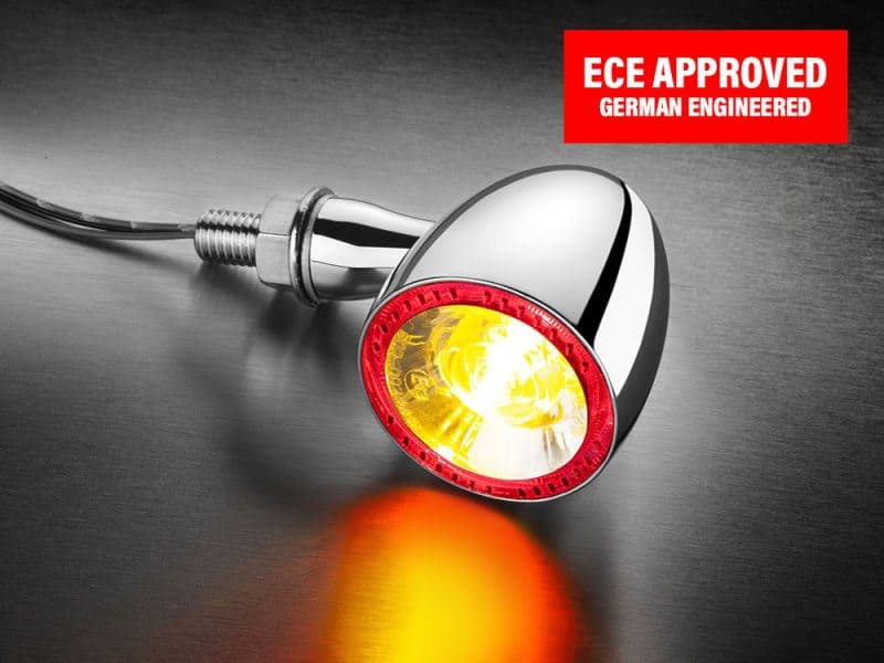 Bright yellow motorcycle indicator with red trim, chrome finish, and ECE approved German engineering.