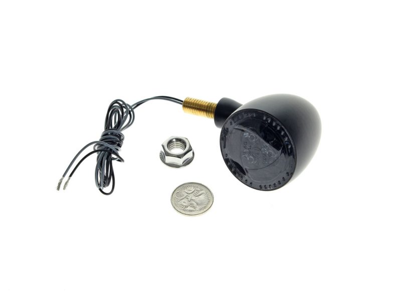 Black motorcycle LED indicator light with wiring and mounting hardware for Revelry Motorcycles.