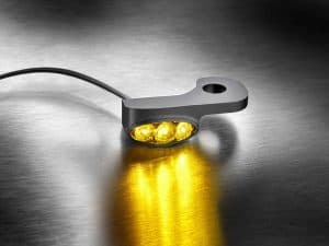 LED motorcycle tail light for Revelry Motorcycles, sleek black design with yellow illumination.