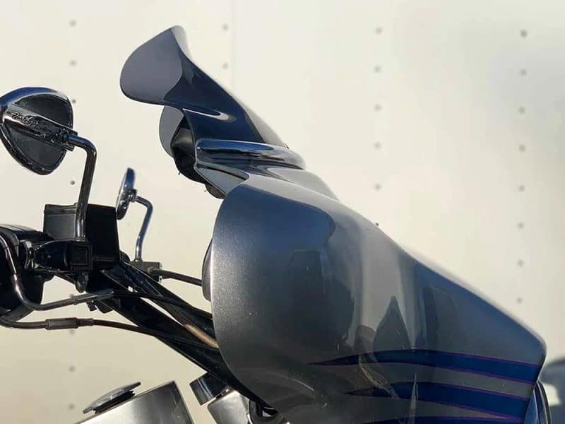 6.5in. Flare Windshield - Dark Smoke. Fits Electra Glide & Ultra 1986-1995. Front fairing and handlebar of a motorcycle from Revelry Motorcycles in Australia.