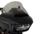 Dark motorcycle fairing with dual headlights and tinted windscreen, stylish design for custom bike enthusiasts.