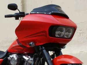 High-performance red Harley Davidson motorcycle with sleek design and custom lighting.