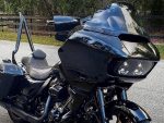 Black touring motorcycle with a large front fairing and windscreen, perfect for long-distance rides.