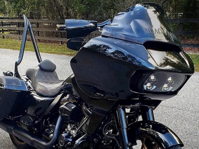 Black touring motorcycle with a large front fairing and windscreen, perfect for long-distance rides.