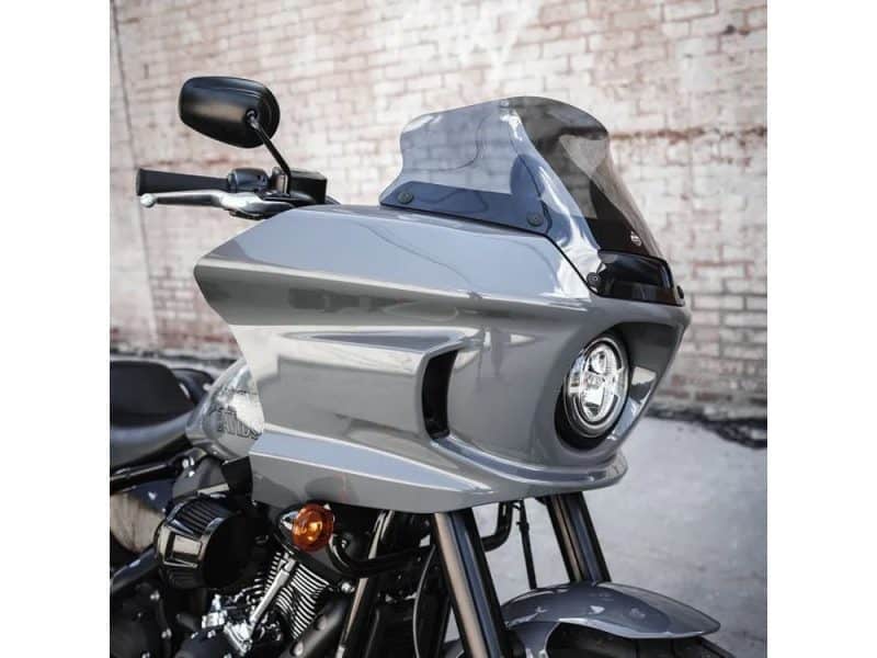 Sleek grey motorcycle with tinted windshield and modern design, ideal for motorcycle enthusiasts.