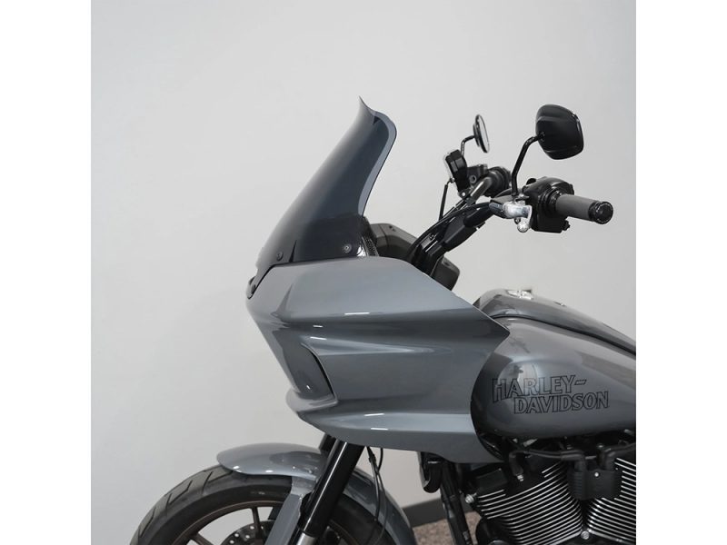 10in. Flare Windshield - Dark Smoke. Fits Low Rider ST 2022up Harley Davidson touring motorcycle with sleek grey fairing and handlebar, ideal for long-distance cruising.