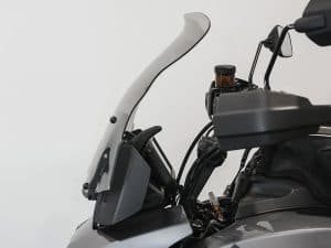 Aviation-style motorcycle windscreen with clip-on attachment for enhanced ride comfort.