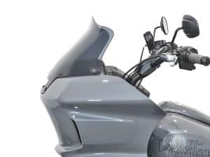 Sleek grey Harley Davidson motorcycle with windscreen and modern handlebar design.