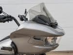 Sleek silver touring motorcycle with advanced windscreen and modern Harley-Davidson design, perfect for long rides.