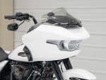 Sleek white Harley Davidson motorcycle with aerodynamic fairing and advanced LED headlight.