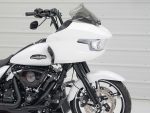 Harley Davidson touring motorcycle with custom white paint, advanced aerodynamics, and black engine details.