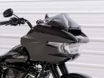 Motorcycle touring helmet on Harley Davidson motorcycle, black full-face helmet with visor.