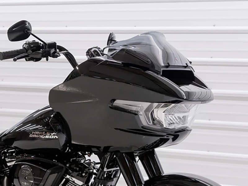 Motorcycle touring helmet on Harley Davidson motorcycle, black full-face helmet with visor.