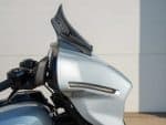Sleek silver motorcycle fairing with aerodynamic design for enhanced performance and style.