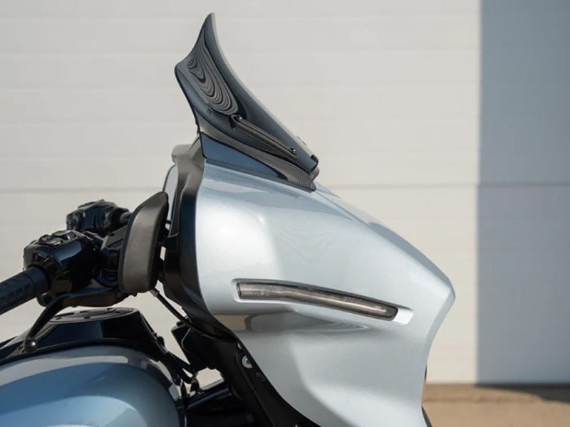 Sleek silver motorcycle fairing with aerodynamic design for enhanced performance and style.