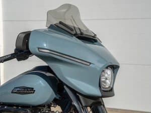 Harley-Davidson motorcycle with modern front fairing and windshield in light blue colour.