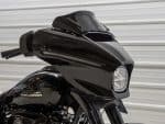 Sleek black Harley Davidson motorcycle front view with custom fairing, ideal for motorcycle enthusiasts and bike customization.