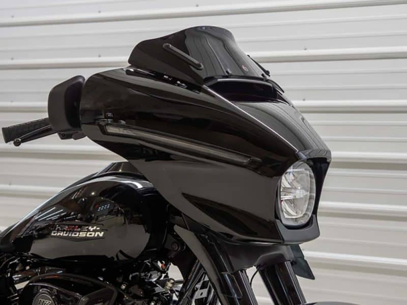 Sleek black Harley Davidson motorcycle front view with custom fairing, ideal for motorcycle enthusiasts and bike customization.