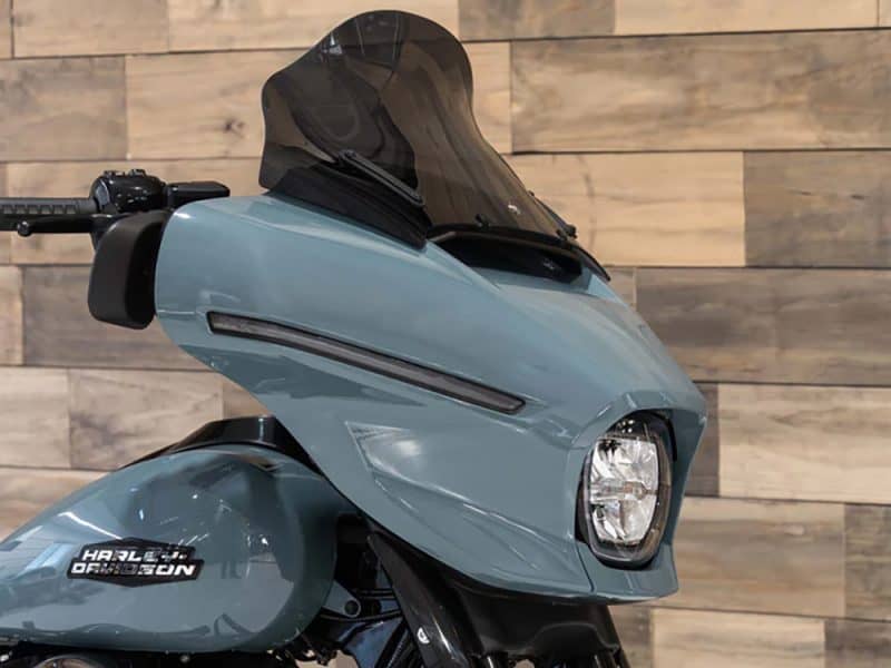 12in. Flare Windshield - Dark Smoke. Fits CVO Street Glide 2023up & Street Glide 2024up Sleek blue Harley Davidson motorcycle with modern fairing and tinted windscreen.