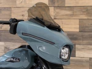 Sleek blue Harley Davidson motorbike front view with windscreen and modern design.