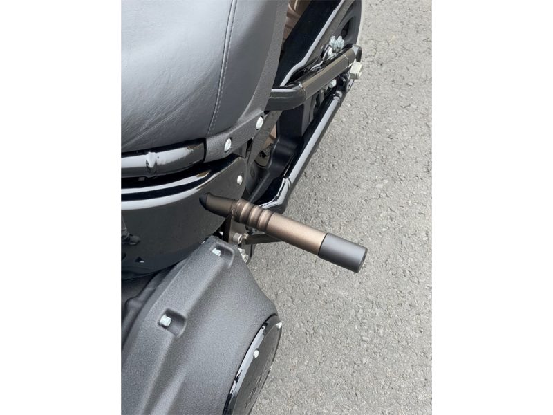Compact motorcycle footpeg and exhaust system for Revelry Motorcycles.