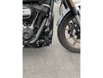 Harley-Davidson motorcycle engine and front wheel close-up, high-quality black matte finish, customisation details.