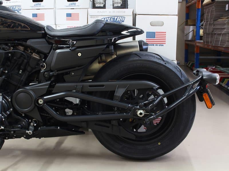 Black motorcycle rear view in a warehouse, Revelry Motorcycles logo, Australian motorcycle shop.