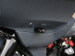 Close-up of a motorbike fairing with a radar detector installed, showcasing sleek design and modern safety features.