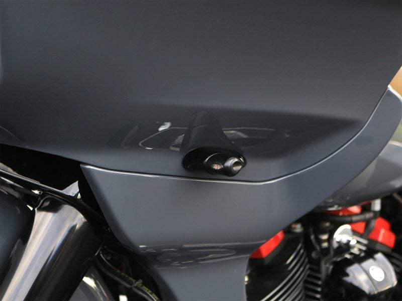 Close-up of a motorbike fairing with a radar detector installed, showcasing sleek design and modern safety features.