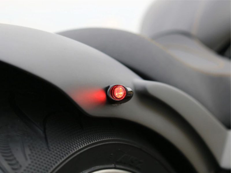 Red LED tail light on a motorcycle, close-up shot emphasizing safety features.