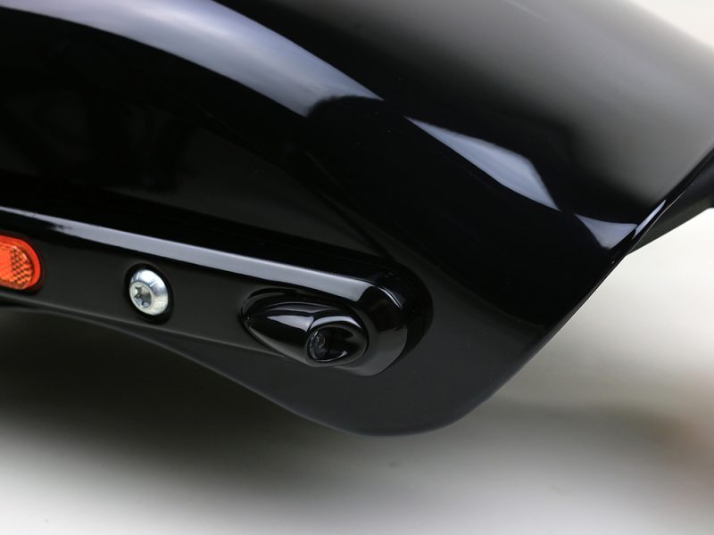 Sleek black motorcycle fairing with integrated camera for modern Revelry Motorcycles.