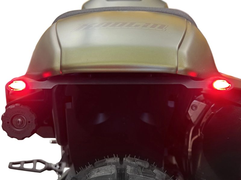 High-performance Revelry Motorcycles adventure bike rear view with illuminated tail lights.