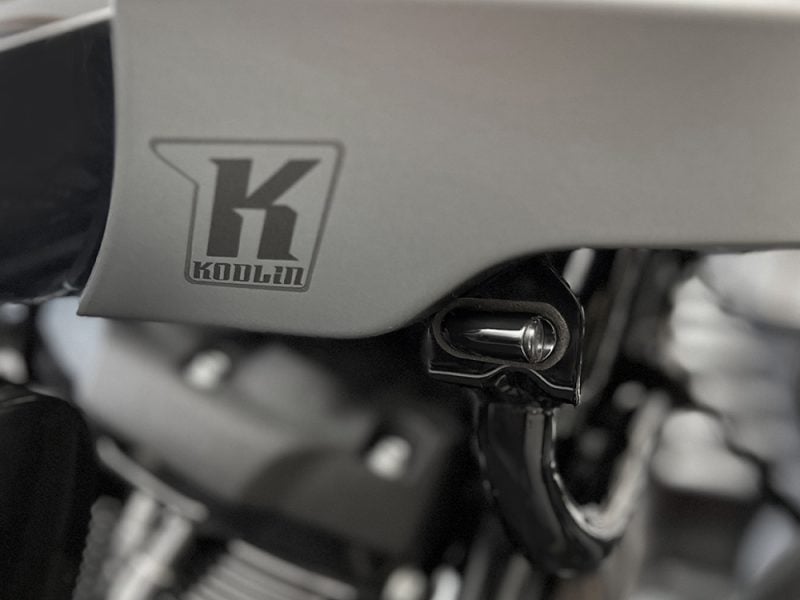 Koollin motorcycle logo on engine part, high-quality close-up shot, technology and repair focus.