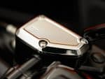 Shiny motorcycle engine detail with chrome finish and intricate design.