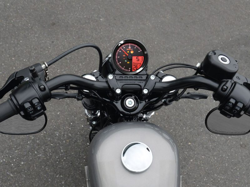 Sleek motorcycle handlebars with digital display and modern controls, perfect for motorcycle enthusiasts.