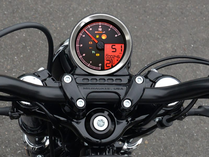 High-resolution motorcycle dashboard with digital and analog displays, capturing the essence of stylish Revelry Motorcycles.
