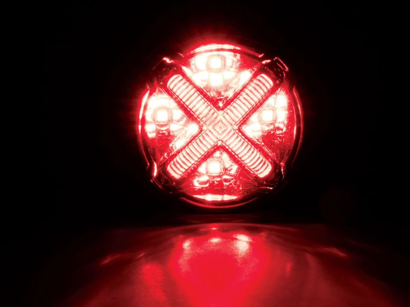 Red LED motorcycle tail light with X-mark design for enhanced visibility and safety.
