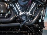 Vivid close-up of a motorcycle engine showcasing powerful black exhaust pipes and chrome accents - perfect for motorcycle enthusiasts.