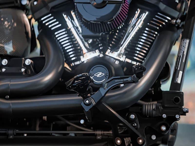 Vivid close-up of a motorcycle engine showcasing powerful black exhaust pipes and chrome accents - perfect for motorcycle enthusiasts.