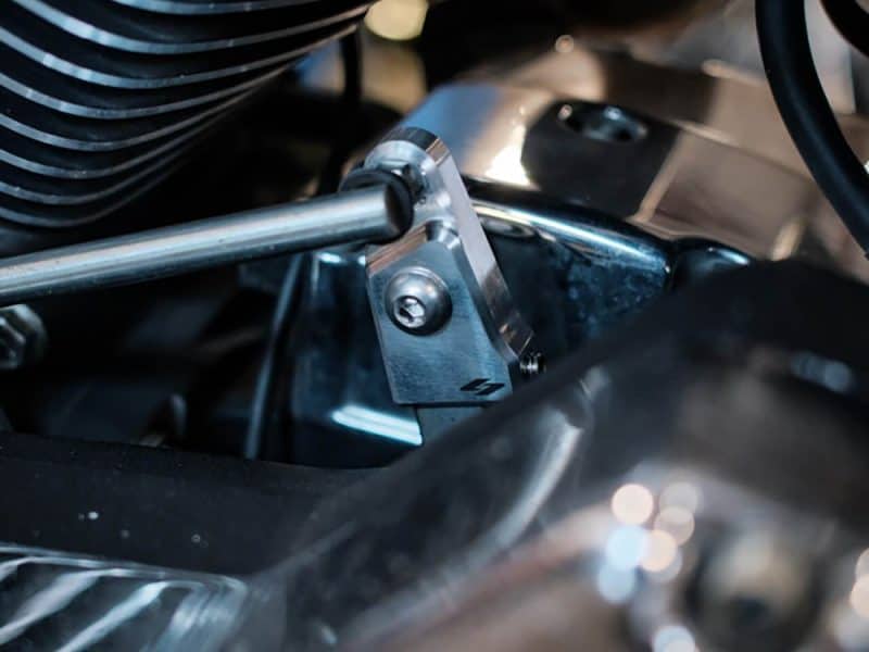 High-performance motorcycle engine part with metallic finish.