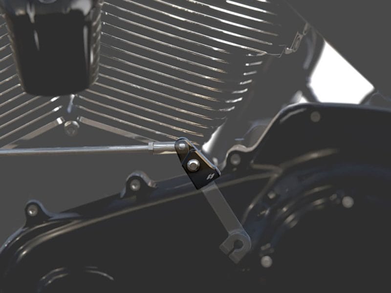 High-performance motorcycle engine component on black metallic background.