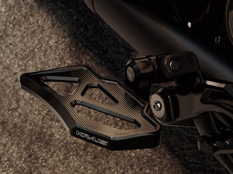 High-quality motorcycle footpeg with sleek black design for enhanced riding performance.
