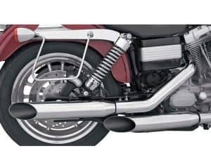 Vintage motorcycle exhaust system and rear wheel showcasing classic cruiser style.