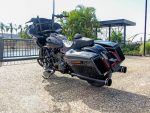 High-end black touring motorcycle with saddlebags, windscreen, and custom exhausts.