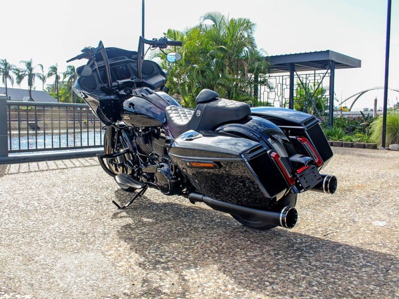 High-end black touring motorcycle with saddlebags, windscreen, and custom exhausts.